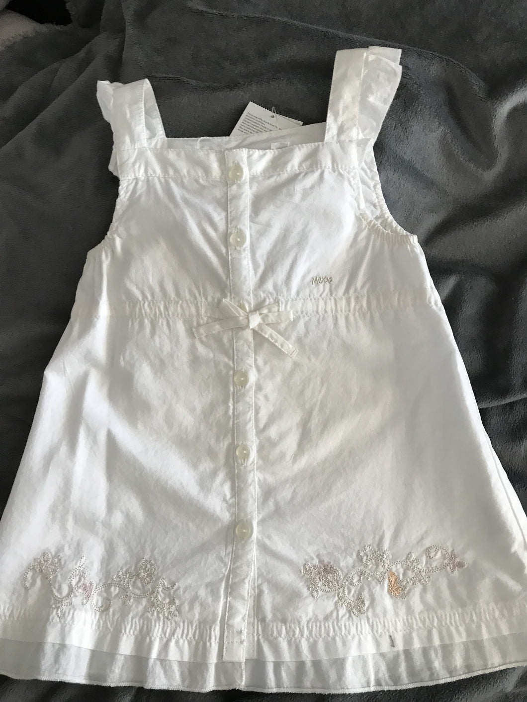 White embroidered baby dress.